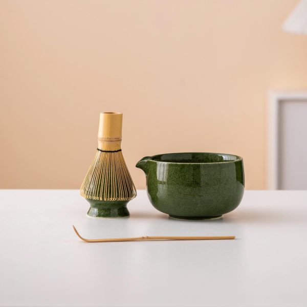 Green ceramic matcha bowl set with spout, bamboo whisk, and holder