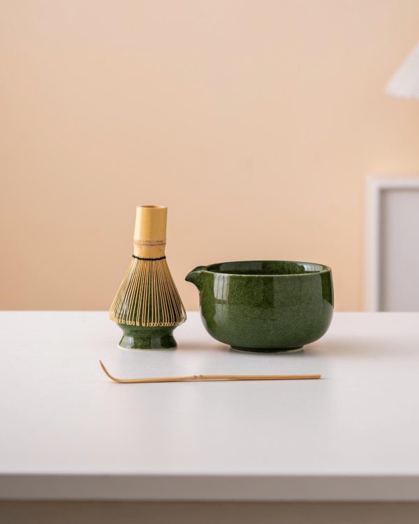 Green ceramic matcha bowl set with spout, bamboo whisk, and holder